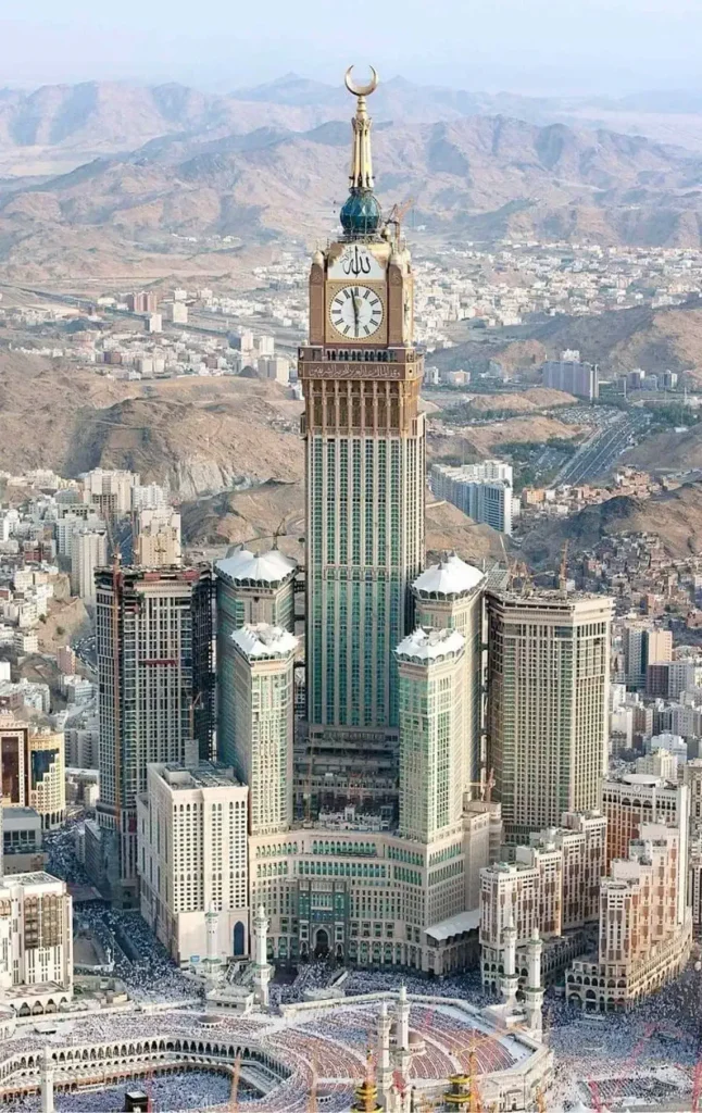 Witness the majestic Abraj Al-Bait Clock Tower in Mecca, Saudi Arabia, a blend of faith and modernity, overlooking the sacred Kaaba and offering breathtaking city views.