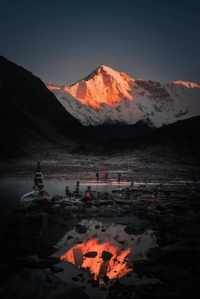 A mesmerizing view of Cho Oyu, the sixth highest peak in the world, standing proudly in the Himalayan range with its snow-capped summit and rugged slopes, beckoning adventurers to conquer its majestic heights and embrace the thrill of mountain exploration.
